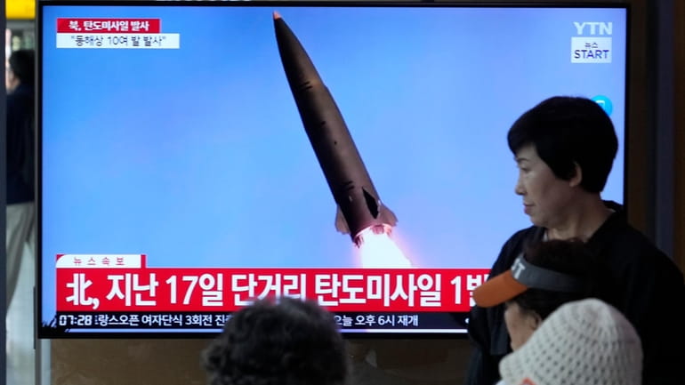 A news program broadcasts a file image of a missile...