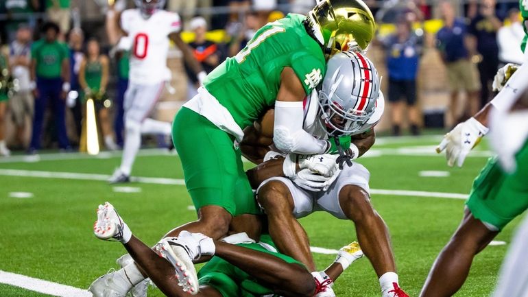 Notre Dame safety Ramon Henderson, left, and cornerback Cam Hart,...