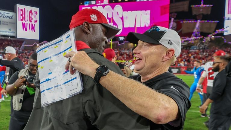 Tampa Bay Buccaneers head coach Todd Bowles, left, greets Carolina...