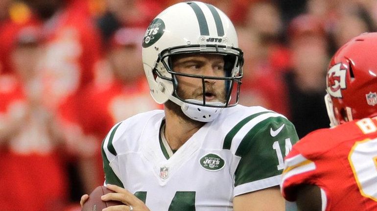 New York Jets' Ryan Fitzpatrick prepares to throw as center...