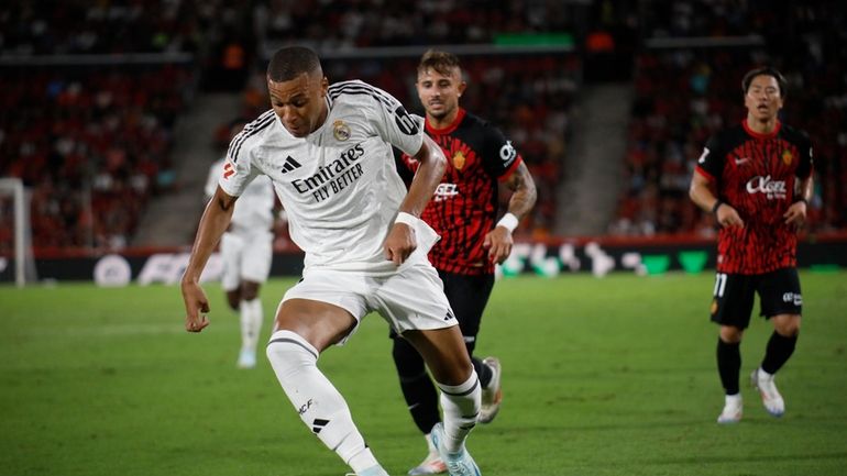 Real Madrid's Kylian Mbappe runs with the ball during a...