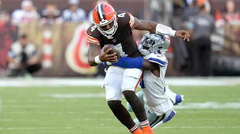 Cleveland Browns quarterback Deshaun Watson (4) is tackled by Dallas...