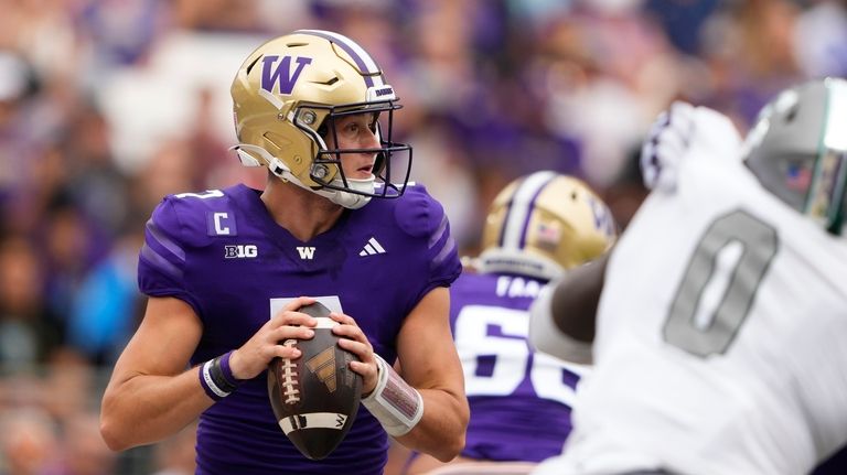 Washington quarterback Will Rogers looks to throw during the first...