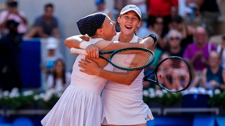 Mirra Andreeva and Diana Shnaider of Individual Neutral Athlete celebrate...