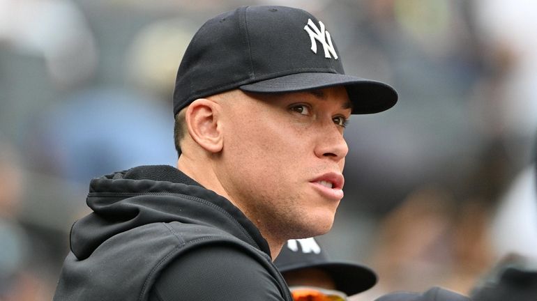 The Yankees' Aaron Judge looks on from the dugout during...