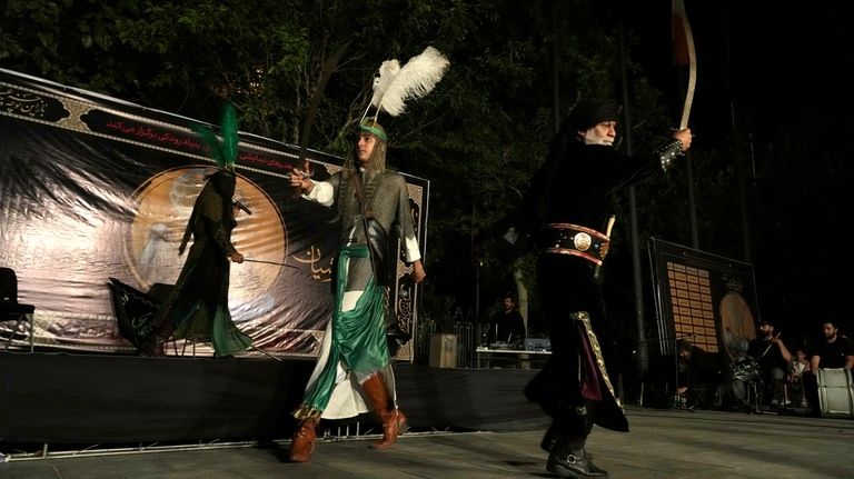 Iranian actors play in a traditional theatre, called Tazieh, re-enacting...