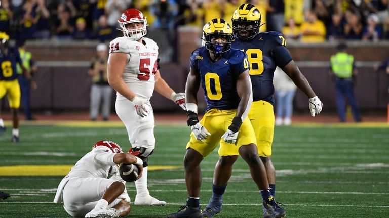 Michigan defensive end Josaiah Stewart (0) celebrates after sacking Fresno...