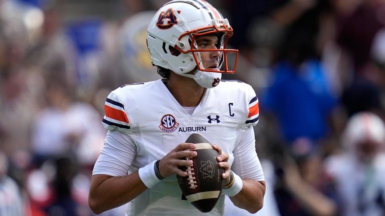 Auburn quarterback Payton Thorne (1) looks to pass down field...