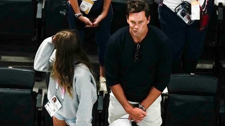 Tom Brady watches the end of the women's artistic gymnastics...