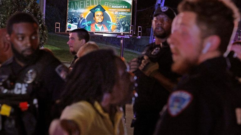 Protesters lash out verbally at Ferguson, Mo., police on Friday,...