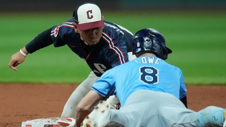 Cleveland Guardians second baseman Andres Gimenez, left, tags out Tampa...