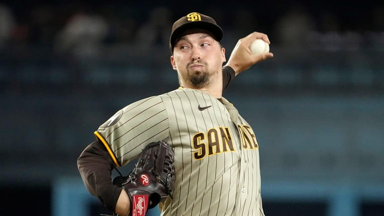 FILE -San Diego Padres starting pitcher Blake Snell throws to...