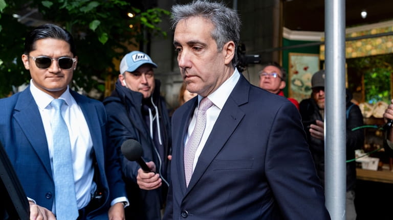 Michael Cohen leaves his apartment building on his way to...