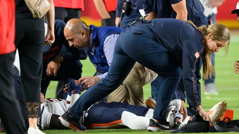 Chicago Bears safety Douglas Coleman III, bottom, is treated on...