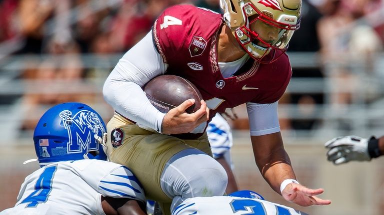 Florida State quarterback DJ Uiagalelei (4) tries to jump over...