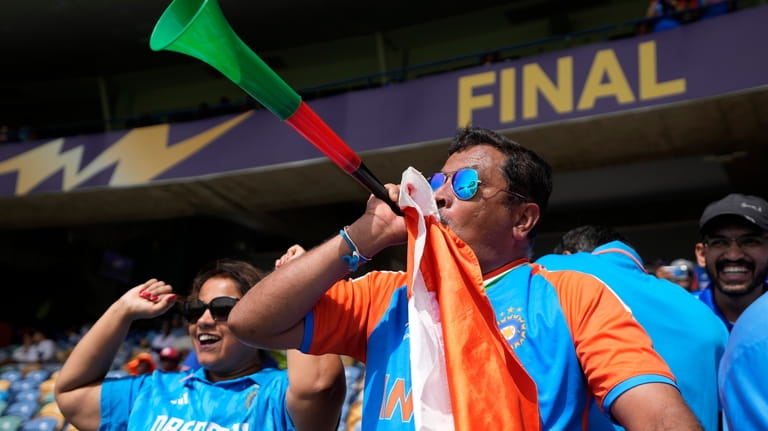 Indian supporters cheer for their team before the start of...