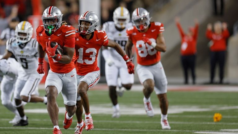 Ohio State running back Quinshon Judkins, front left, has a...