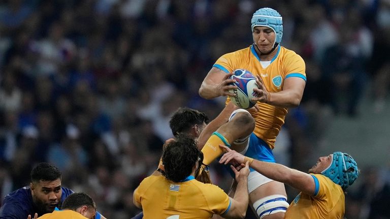 Uruguay's Felipe Aliaga, top, catches the ball during the Rugby...