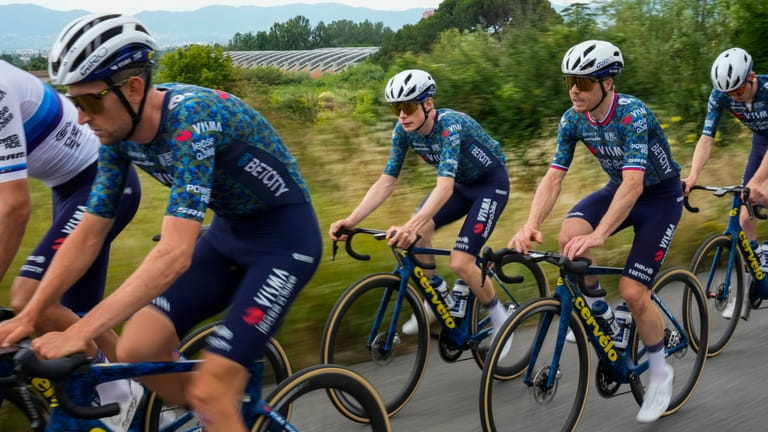 Denmark's Jonas Vingegaard, center, and Visma-Lease a Bike fellow team...