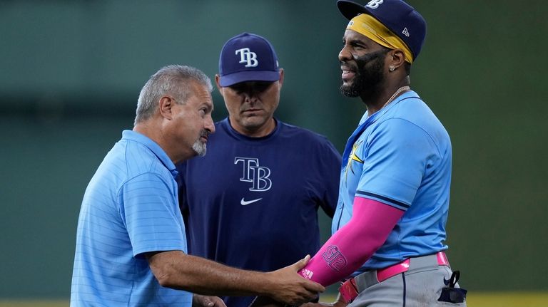 Tampa Bay Rays first baseman Yandy Díaz, right, is checked...