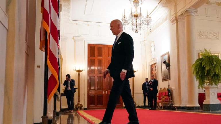 President Joe Biden walks from the podium after speaking in...