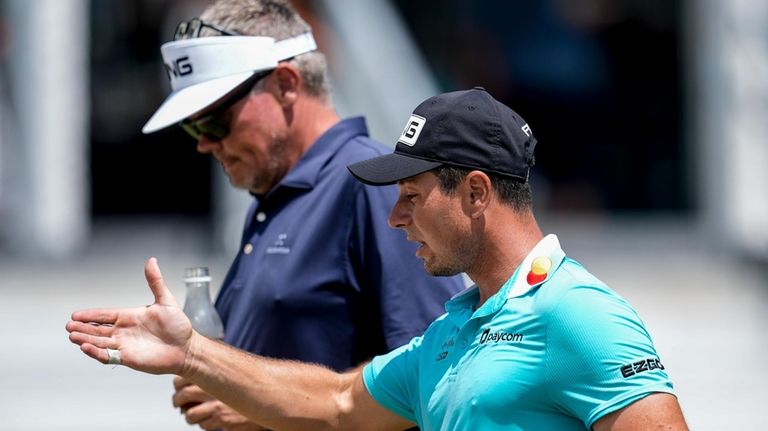 Viktor Hovland, of Norway, walks down the 10th fairway during...