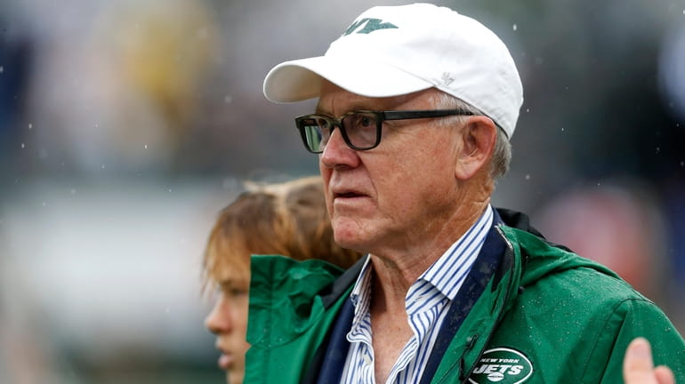 Jets owner Woody Johnson watches his team warm up before...