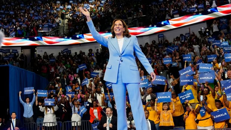 Vice President Kamala Harris waves during a campaign rally, Tuesday,...