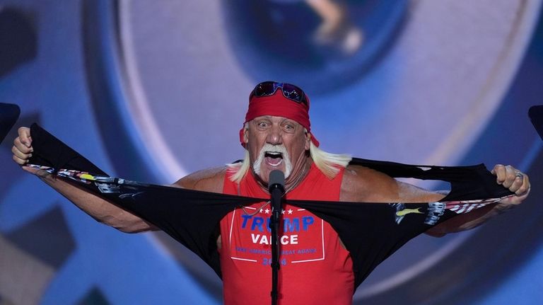 Hulk Hogan tears off his shirt while speaking on the...