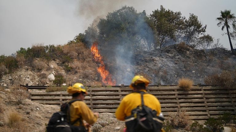 Fire crews monitor the Line Fire Saturday, Sept. 7, 2024,...