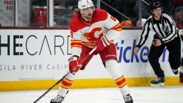 FILE -Calgary Flames defenseman Chris Tanev looks to pass the...