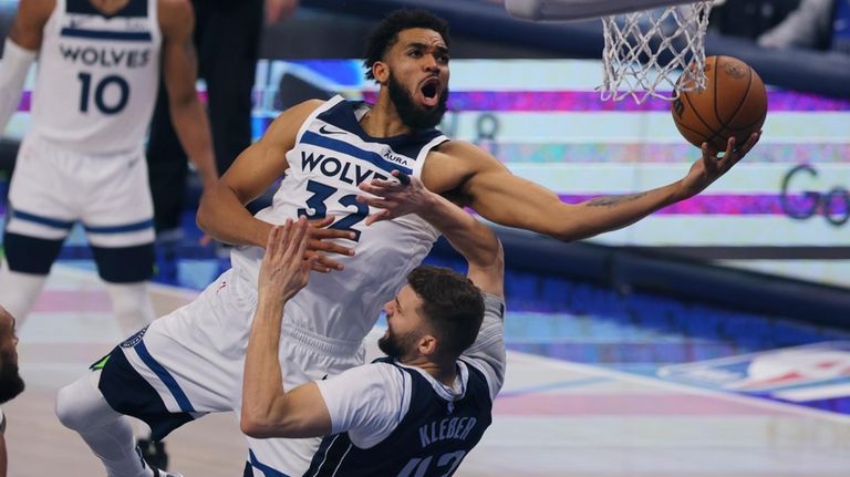 Minnesota Timberwolves center Karl-Anthony Towns (32) drives to the basket...