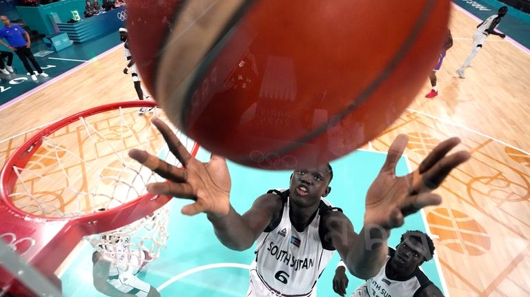 Khaman Maluach, of South Sudan, reaches for a rebound in...