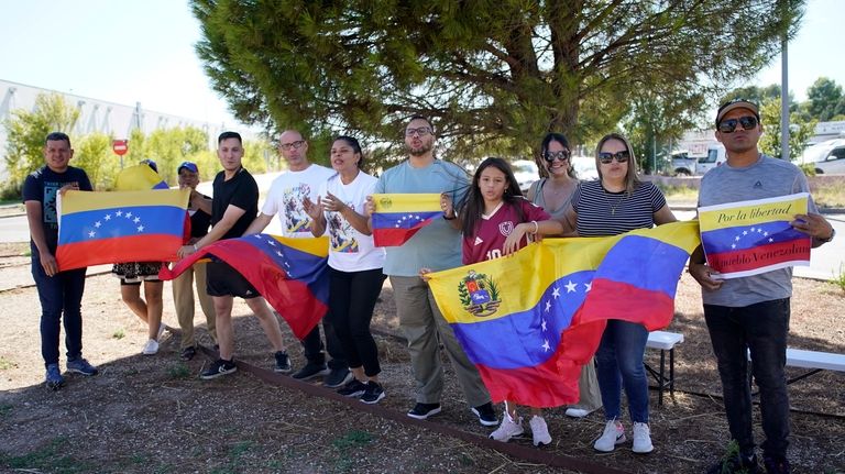 Supporters of Edmundo González wait for his arrival outside the...