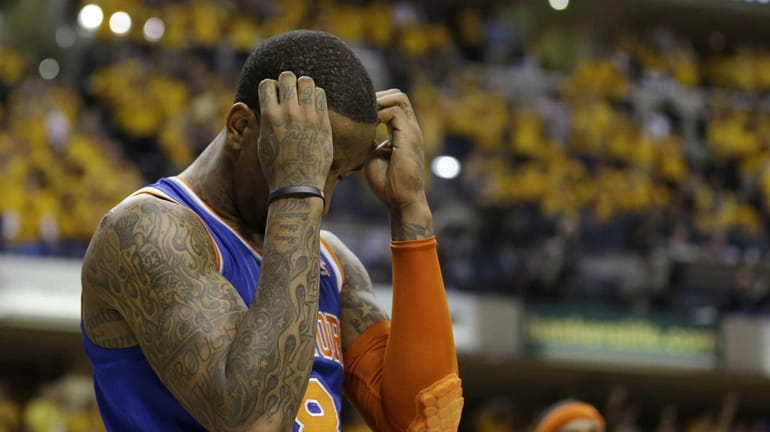 Knicks' J.R. Smith reacts late during the second half of...
