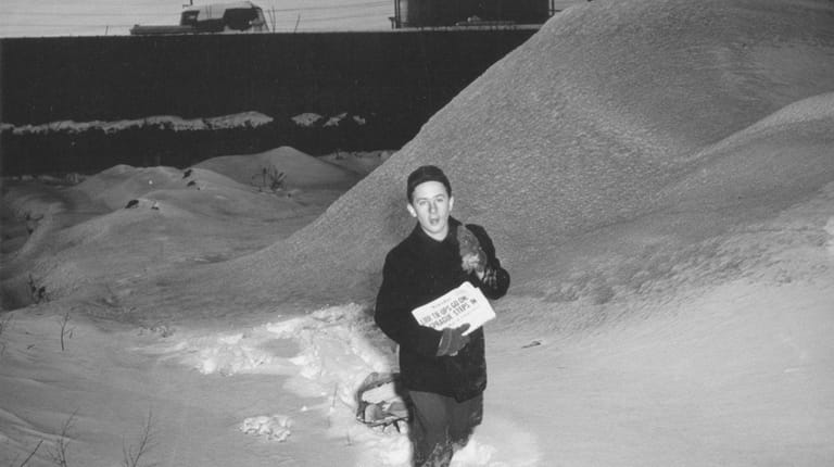 A Newsday carrier delivers the paper through the snow in...