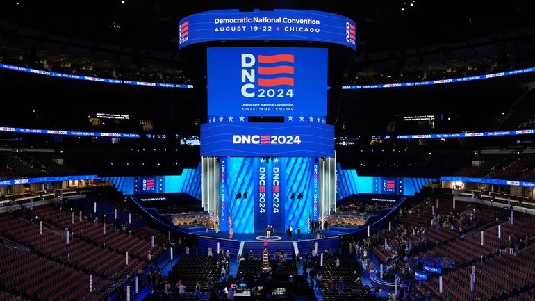 Workers prepare the convention floor at United Center before the...