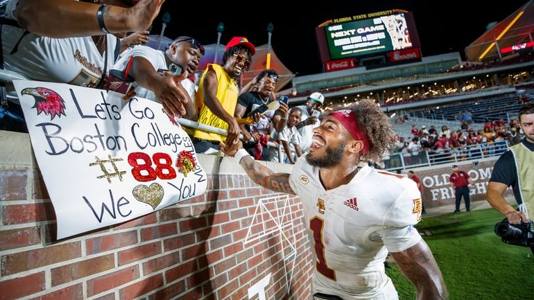 Boston College quarterback Thomas Castellanos (1) celebrates with fans after...