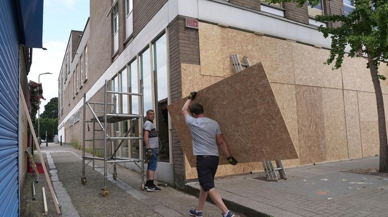 Windows are boarded up ahead of an anti-immigration protest in...