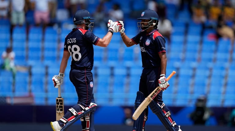 United States' Andries Gous, left, and batting partner Harmeet Singh...