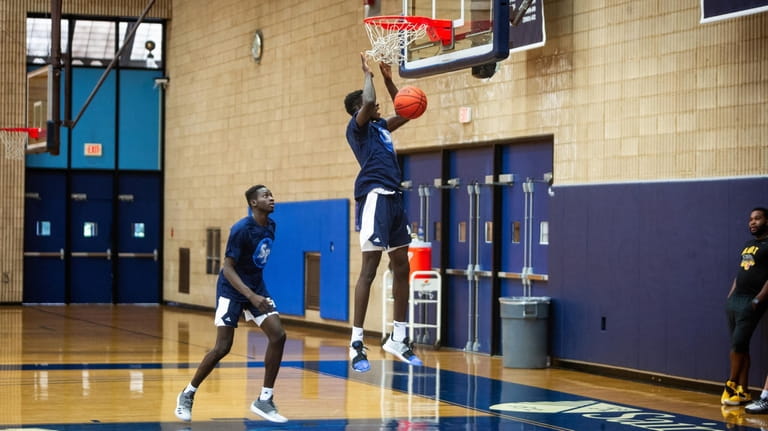 Hassan Drame dunks during basketball practice with twin brother, Fousseyni,...