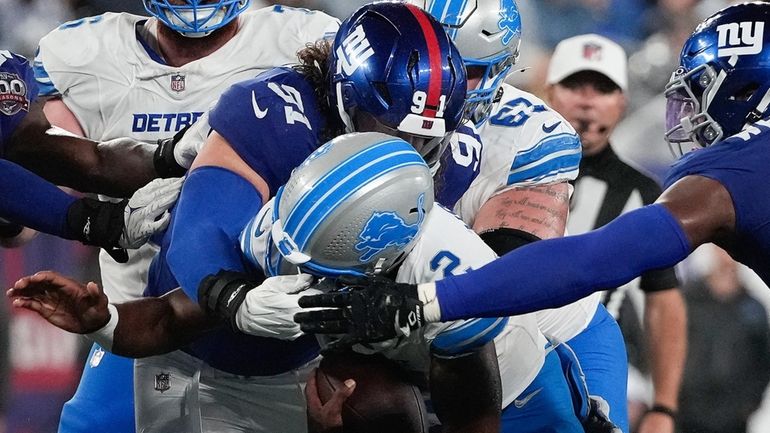 Lions quarterback Hendon Hooker is sacked by Giants defensive tackle...