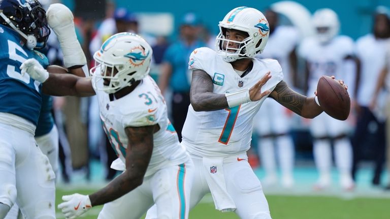 Miami Dolphins quarterback Tua Tagovailoa (1) aims a pass during...