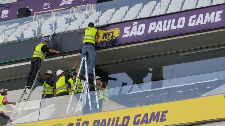 Men work to prepare the Soccer Neo Química Arena in...