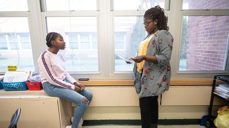 Brentwood High School student Neomi Washington, 15, left, a participant...