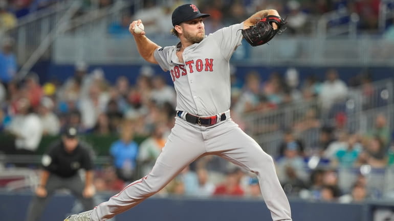 Boston Red Sox pitcher Kutter Crawford (50) aims a pitch...
