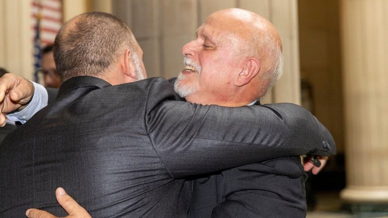 Paul Scrimo embraces his son Anthony at Nassau County Court in Mineola on...