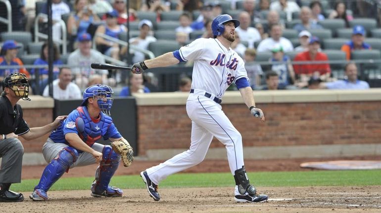 Ike Davis watches his third-inning two-run home run clear the...