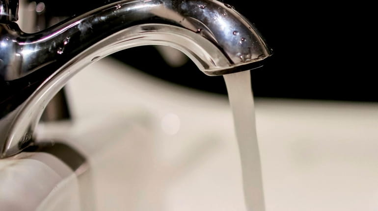 Water runs from a faucet in Bethpage on Feb. 17,...