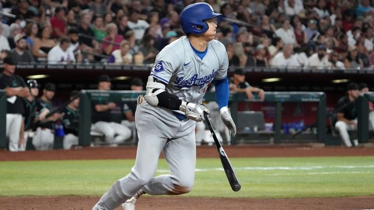 Los Angeles Dodgers' Shohei Ohtani hits a single against the...